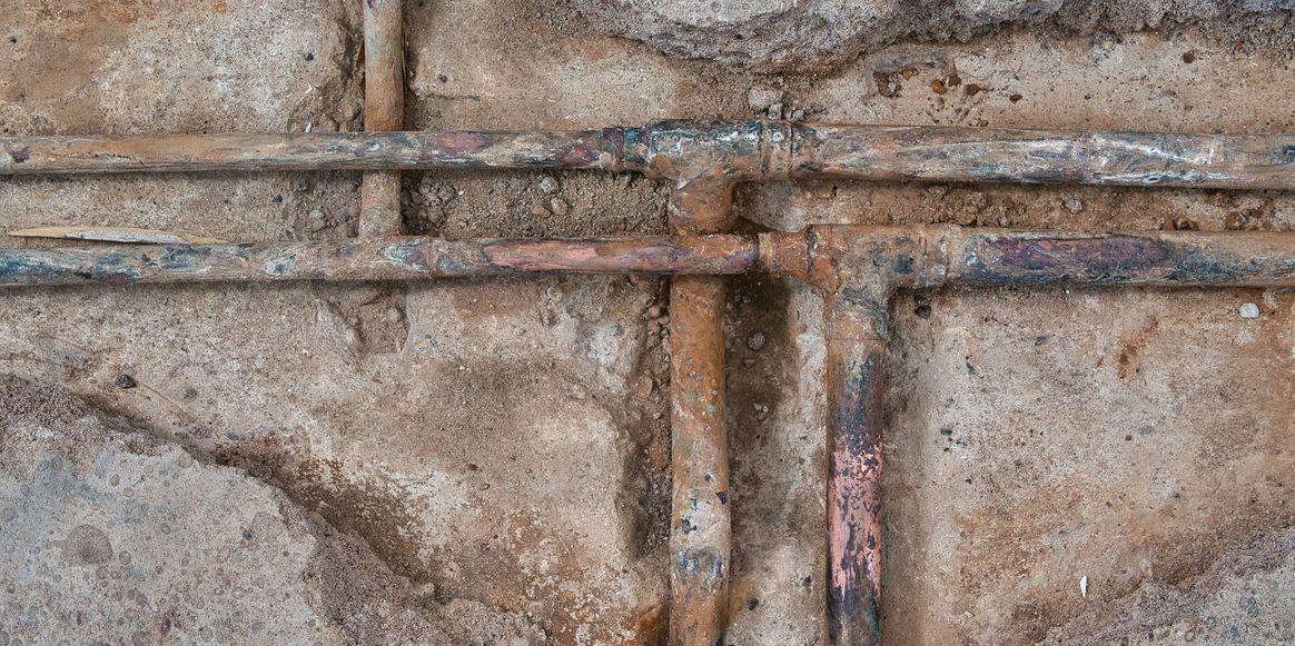 Exposed copper plumbing lines during a leak repair
